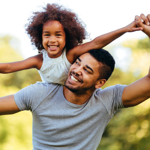 young dad and daughter smiling