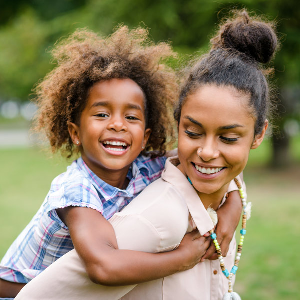 mom and daughter smiling