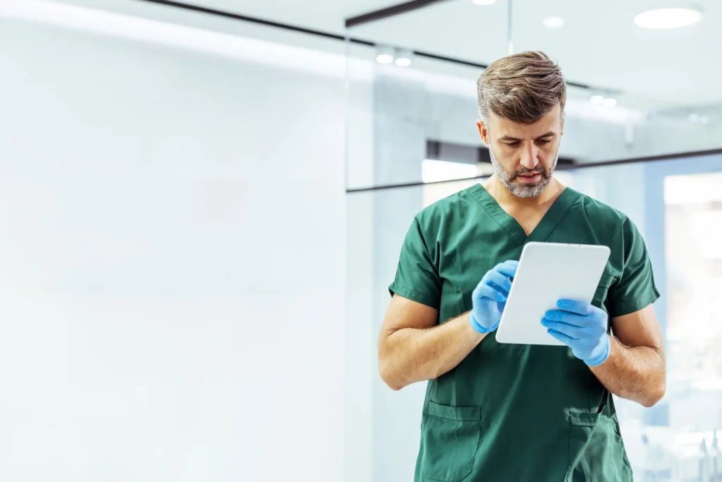 Dentist reviewing patient information during a dental emergency in the Pittsburgh, PA Metro Area