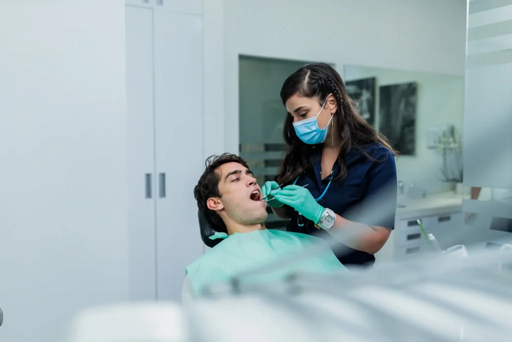 A Dental professional examining a patient’s teeth during a routine checkup in Pittsburgh, PA