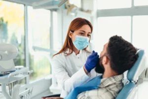 A dental professional performing a smile-enhancing procedure on a patient in Pittsburgh, PA
