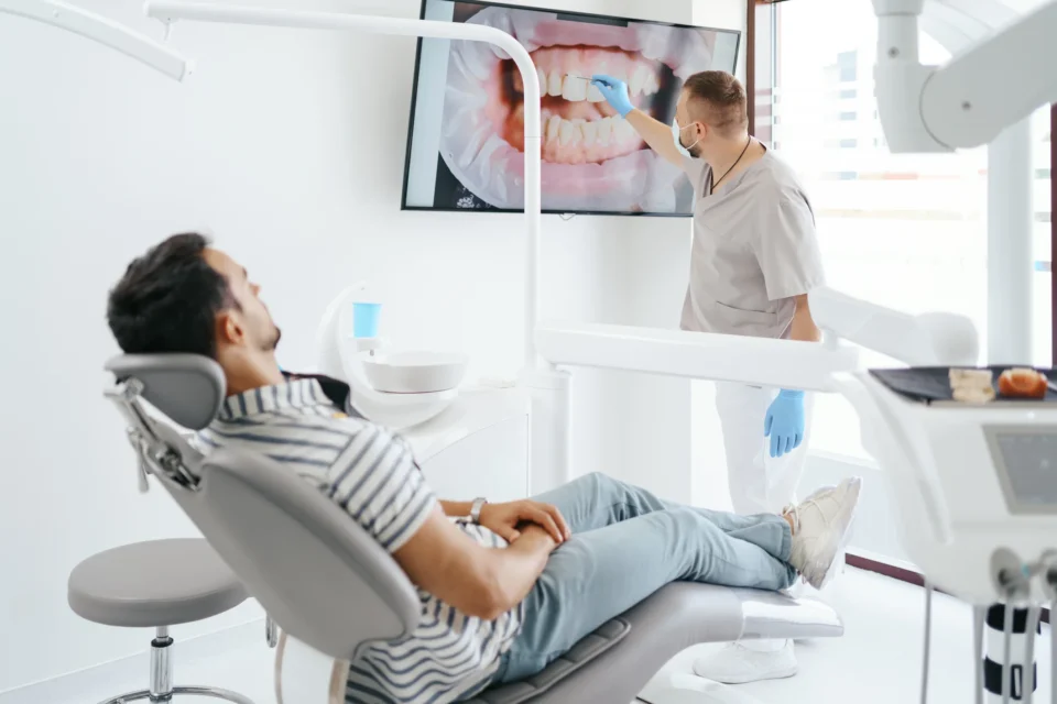 A dentist explaining to a patient during a general dentistry consultation in Pittsburgh, PA