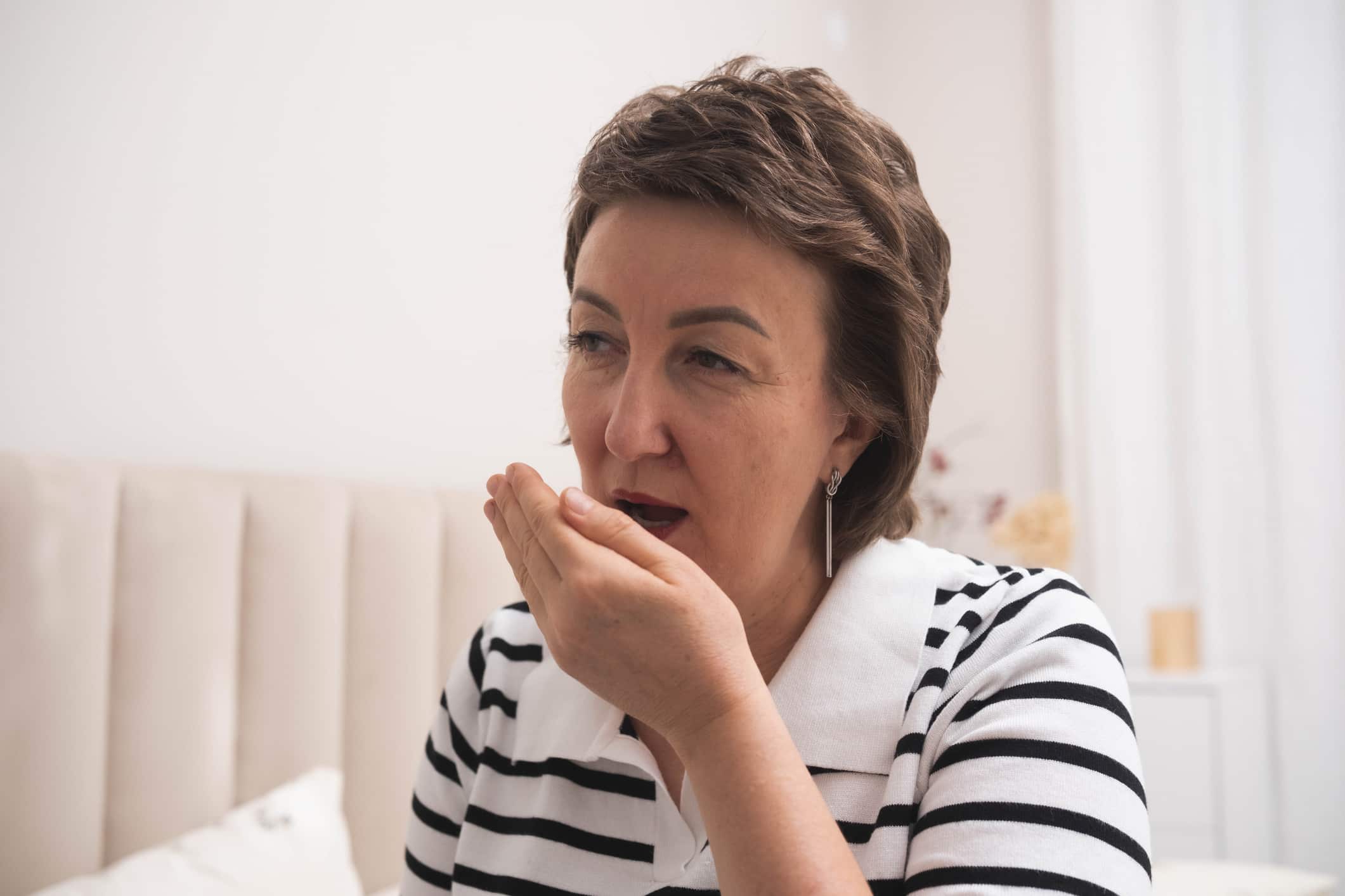 Adult woman experiencing bad breath symptoms in Pittsburgh, PA Metro Area